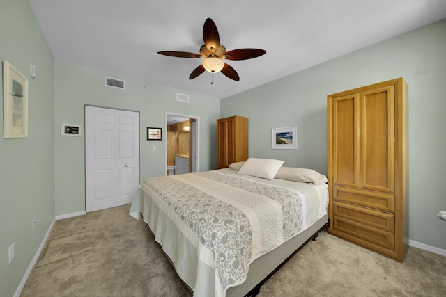 bedroom with ceiling fan, a closet, and light carpet