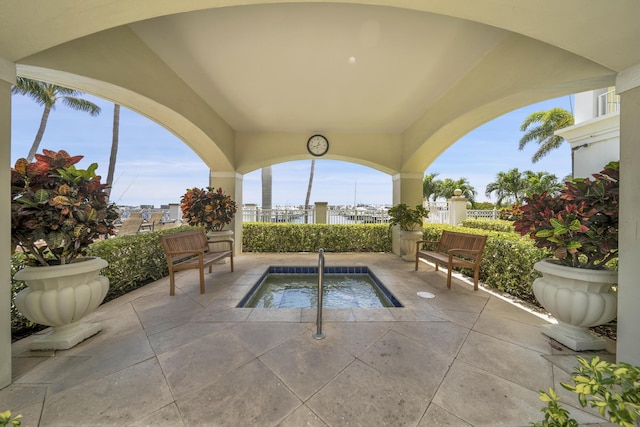 view of swimming pool with an in ground hot tub