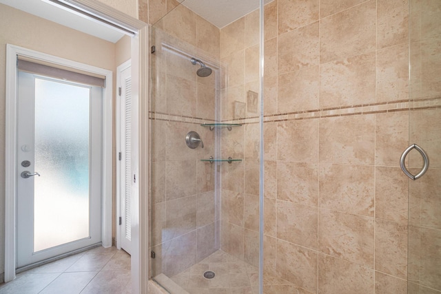 bathroom with tile patterned flooring and a shower with door