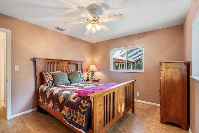 bedroom with ceiling fan and light hardwood / wood-style flooring