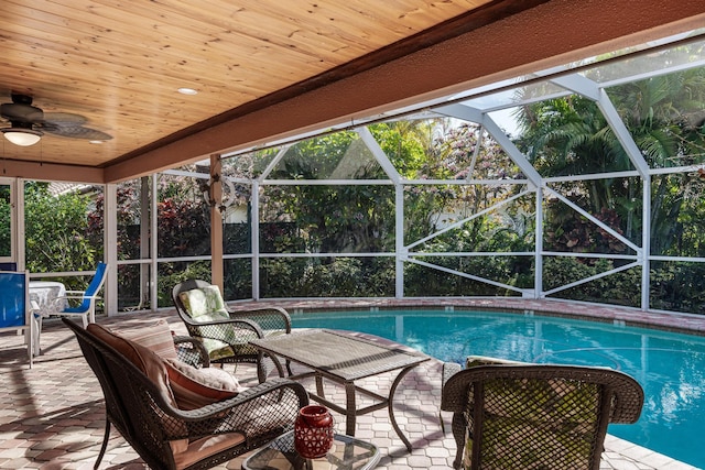 view of swimming pool featuring a patio, a lanai, and ceiling fan