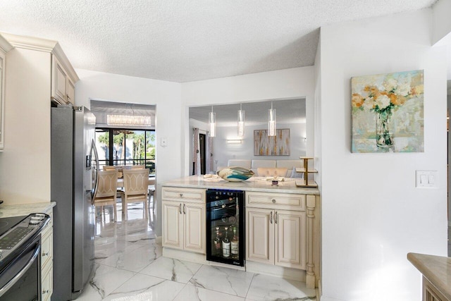 kitchen featuring stainless steel refrigerator with ice dispenser, a textured ceiling, beverage cooler, pendant lighting, and cream cabinets