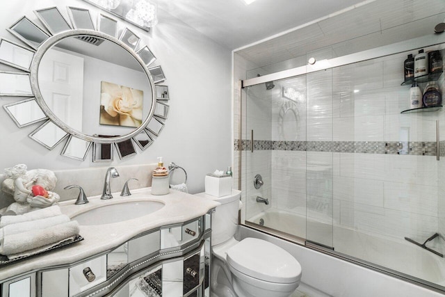 full bathroom with toilet, vanity, and combined bath / shower with glass door