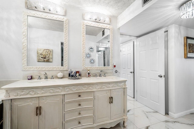 bathroom with a textured ceiling and vanity