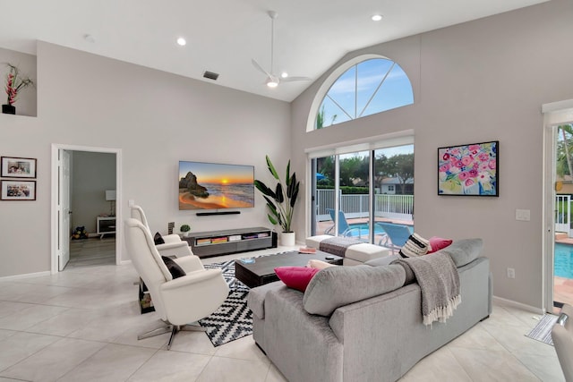 tiled living room featuring ceiling fan and high vaulted ceiling