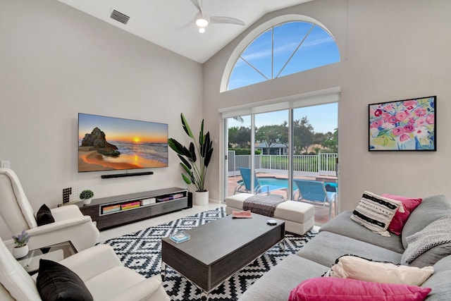 living room featuring high vaulted ceiling and ceiling fan