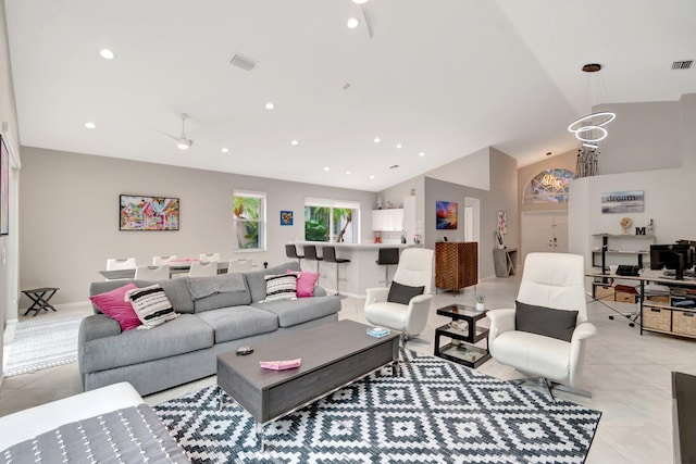 living room with ceiling fan, light tile patterned floors, and lofted ceiling