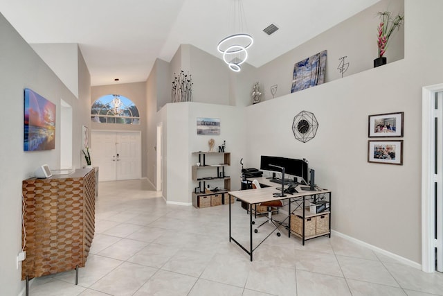 office featuring light tile patterned floors and a high ceiling