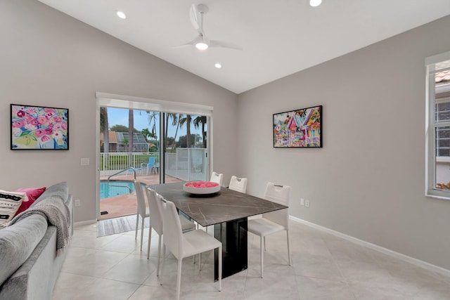 tiled dining room with ceiling fan and lofted ceiling