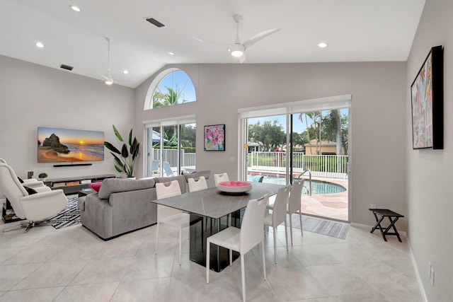 tiled dining area featuring ceiling fan and lofted ceiling