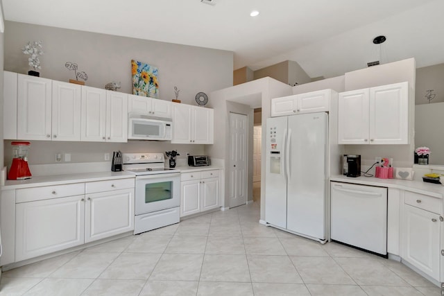 kitchen featuring white cabinets, light tile patterned flooring, white appliances, and vaulted ceiling