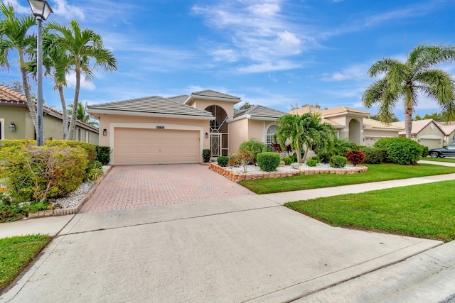 mediterranean / spanish-style home featuring a garage and a front lawn