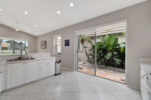 kitchen with white cabinets, ceiling fan, lofted ceiling, and sink