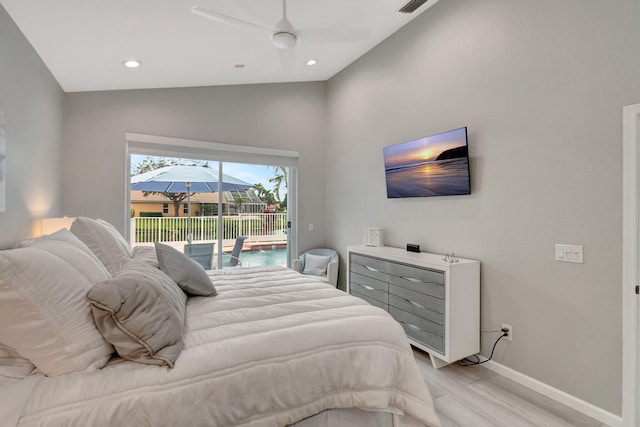 bedroom with access to exterior, light hardwood / wood-style floors, ceiling fan, and lofted ceiling