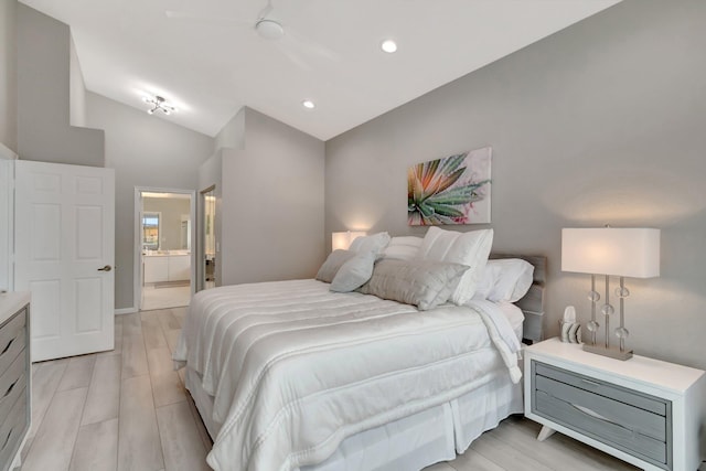 bedroom featuring ensuite bathroom, ceiling fan, lofted ceiling, and light hardwood / wood-style floors