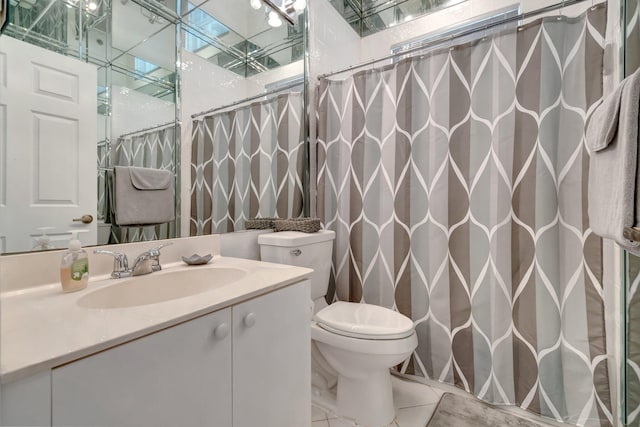 bathroom featuring a shower with shower curtain, vanity, toilet, and tile patterned floors