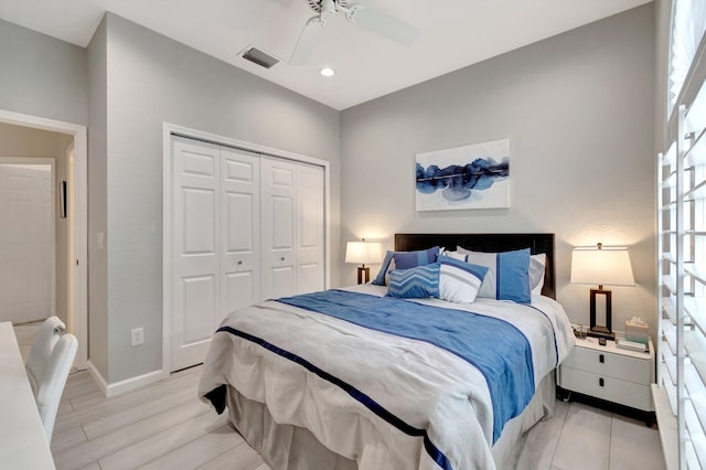 bedroom featuring light wood-type flooring, a closet, and ceiling fan