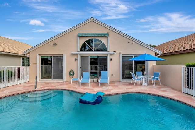 back of property with a patio