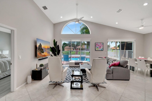 living room with ceiling fan, light tile patterned floors, and high vaulted ceiling