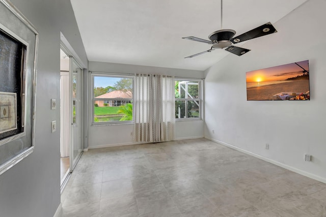 spare room with ceiling fan and lofted ceiling