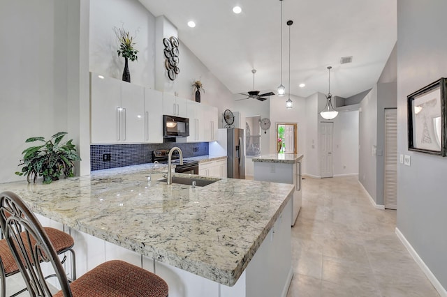 kitchen with white cabinetry, ceiling fan, stainless steel fridge with ice dispenser, kitchen peninsula, and pendant lighting