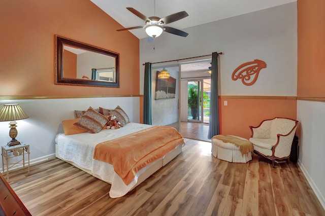 bedroom with access to exterior, hardwood / wood-style flooring, vaulted ceiling, and ceiling fan