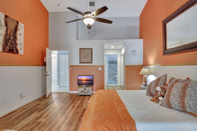 bedroom featuring ensuite bathroom, ceiling fan, and wood-type flooring