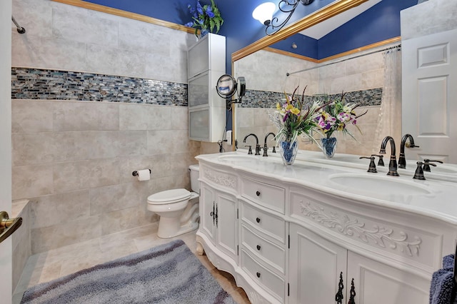 bathroom featuring tile patterned floors, vanity, tile walls, and toilet