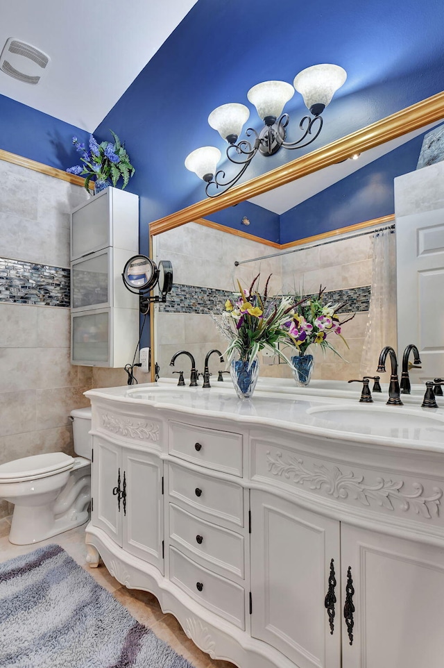 bathroom with vanity, toilet, tile walls, and lofted ceiling