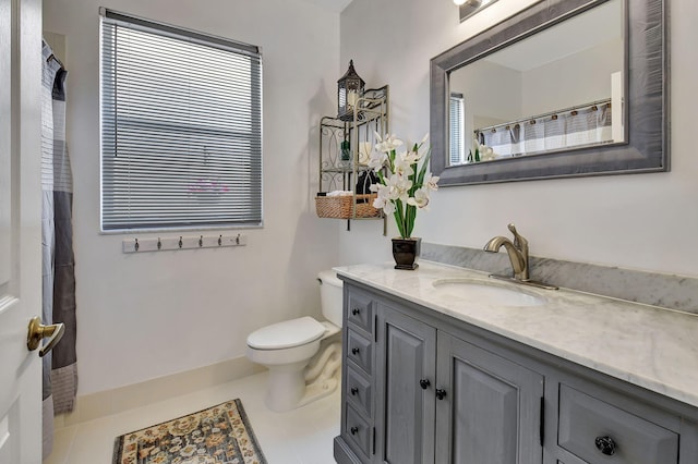 bathroom featuring tile patterned floors, vanity, and toilet