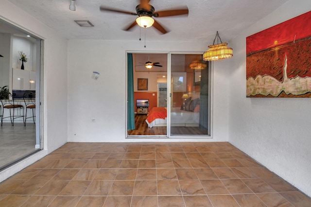 interior space with ceiling fan