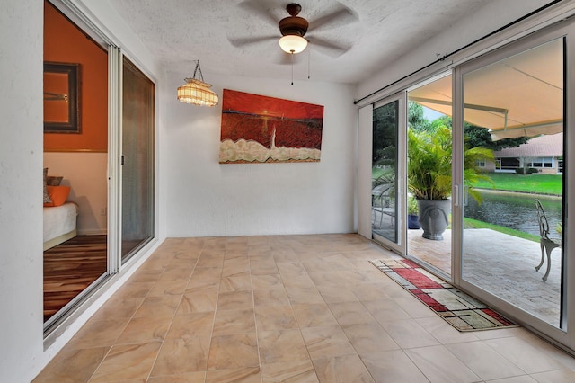 doorway to outside featuring ceiling fan, french doors, vaulted ceiling, a textured ceiling, and light tile patterned flooring