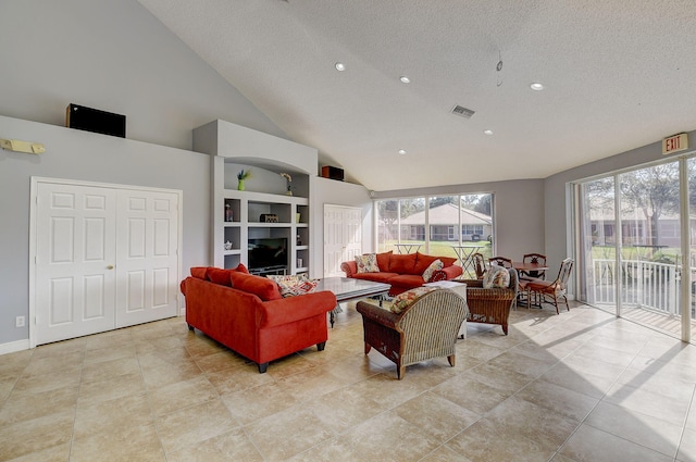 living room featuring built in features, a towering ceiling, a healthy amount of sunlight, and a textured ceiling