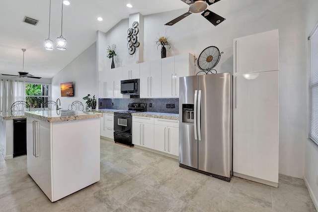 kitchen featuring pendant lighting, high vaulted ceiling, black appliances, a center island with sink, and white cabinets