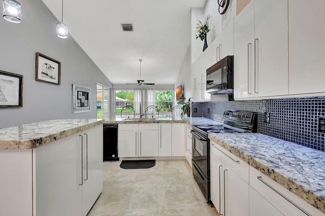 kitchen with backsplash, decorative light fixtures, vaulted ceiling, white cabinets, and black appliances