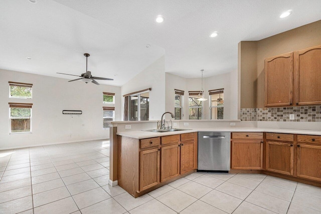 kitchen with backsplash, ceiling fan, sink, dishwasher, and light tile patterned flooring