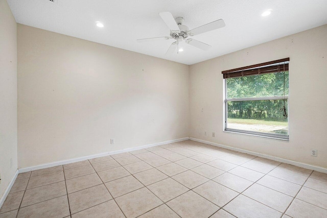 tiled spare room with ceiling fan