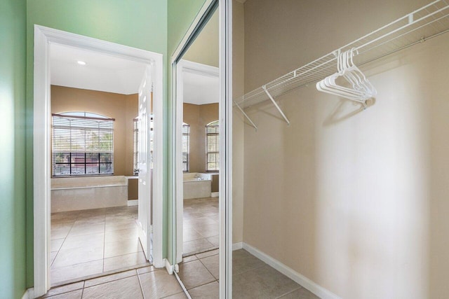 spacious closet with light tile patterned floors