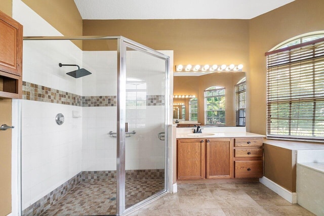 bathroom with vanity and a shower with shower door