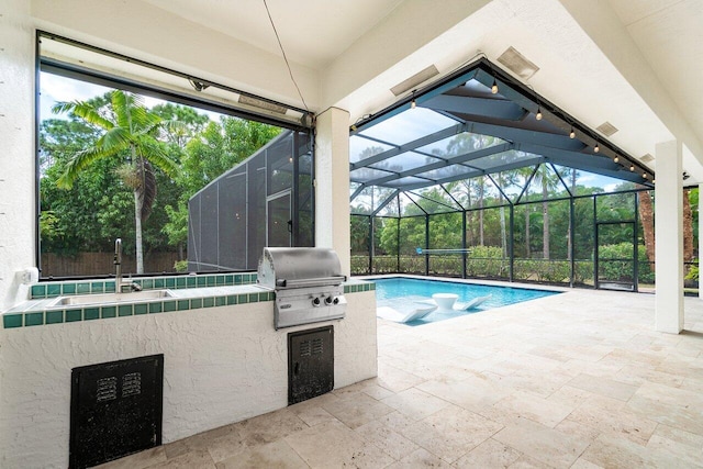 view of swimming pool featuring glass enclosure, a grill, exterior kitchen, and a patio