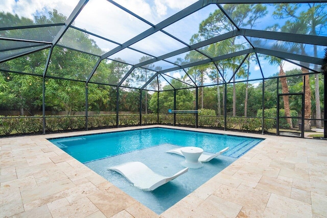 view of swimming pool featuring a patio and glass enclosure