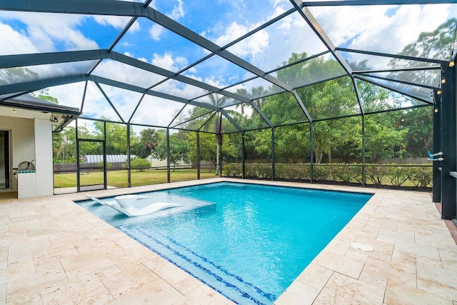 view of pool featuring a lanai, a patio area, and a yard