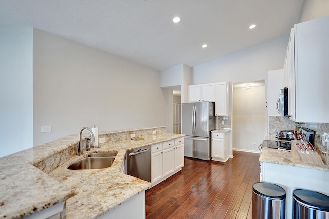 kitchen with sink, white cabinets, light stone counters, and stainless steel appliances