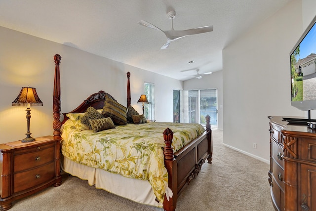 bedroom with a textured ceiling, ceiling fan, light carpet, and vaulted ceiling