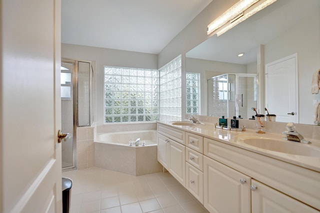 bathroom featuring tile patterned flooring, vanity, and plus walk in shower