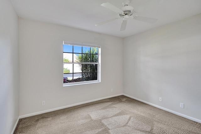 unfurnished room with carpet flooring and ceiling fan