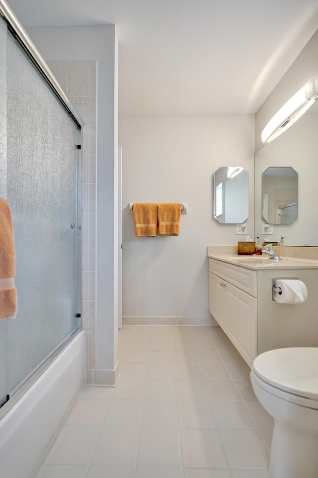 full bathroom with tile patterned flooring, vanity, toilet, and bath / shower combo with glass door