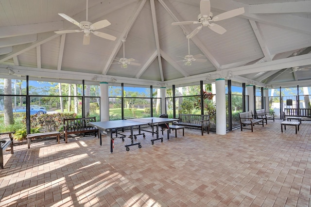 unfurnished sunroom featuring lofted ceiling with beams