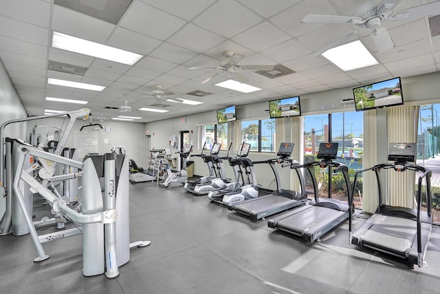 workout area featuring ceiling fan and a drop ceiling