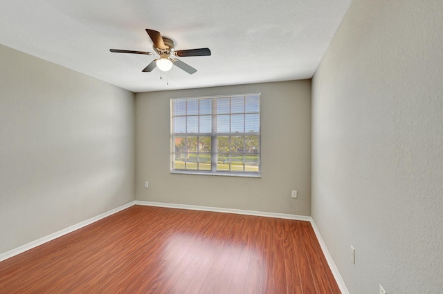 spare room with ceiling fan and hardwood / wood-style floors